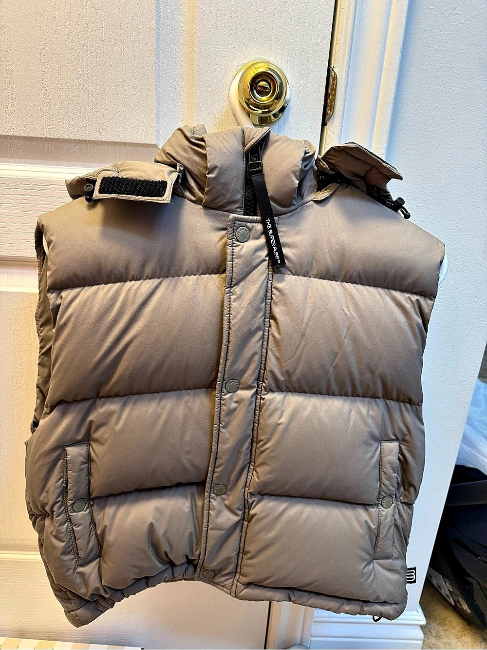 The Super Puff Puffer Vest in Brown beige colour
Size Small
